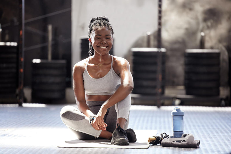 Woman sitting on a yoga mat