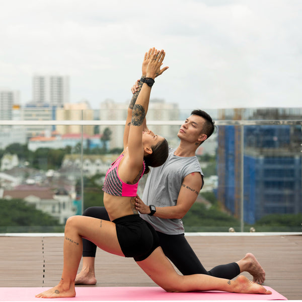 Two people practicing yoga